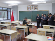 In this photo provided by the North Korean government, North Korean leader Kim Jong Un, left, inspects a class room of a newly built central cadres training school in Pyongyang, North Korea, Tuesday, May 21, 2024. Independent journalists were not given access to cover the event depicted in this image distributed by the North Korean government. The content of this image is as provided and cannot be independently verified. Korean language watermark on image as provided by source reads: &ldquo;KCNA&rdquo; which is the abbreviation for Korean Central News Agency.