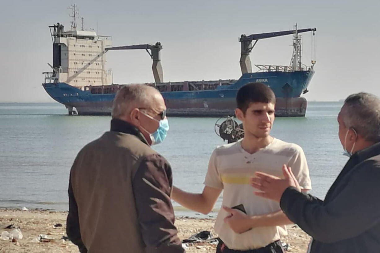 This photo provided by the International Transport Workers&rsquo; Federation shows Mohammad Aisha, center, near the abandoned cargo ship MV Aman in Egyptian waters in March 2021. In 2021 reports surfaced that he was living alone on the ship, forced to swim to shore for food and water. Though he left the ship in 2021, the case is still working its way through the courts three years later. He has not yet been paid, the ITF said.