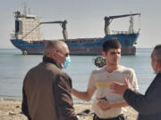 This photo provided by the International Transport Workers&rsquo; Federation shows Mohammad Aisha, center, near the abandoned cargo ship MV Aman in Egyptian waters in March 2021. In 2021 reports surfaced that he was living alone on the ship, forced to swim to shore for food and water. Though he left the ship in 2021, the case is still working its way through the courts three years later. He has not yet been paid, the ITF said.