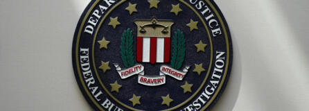 FILE - An FBI seal is seen on a wall on Aug. 10, 2022, in Omaha, Neb. The FBI says scammers stole more than $3.4 billion from older Americans last year. An FBI report released Tuesday shows a rise in losses through increasingly sophisticated tactics to trick the vulnerable into giving up their life savings.