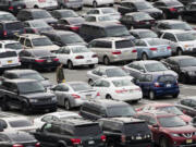 FILE - A person walks through a parking lot at a shopping mall on Dec. 8, 2016 in King of Prussia, Pa. Many newer cars use wireless key fobs and push-button starters. The technology makes it more convenient to get into your vehicle, but it also makes things easier for thieves.