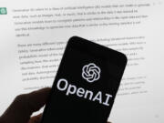 FILE - The OpenAI logo is seen on a mobile phone in front of a computer screen displaying output from ChatGPT, March 21, 2023, in Boston. OpenAI has introduced a new artificial intelligence model. It says it works faster than previous versions and can reason across text, audio and video in real time.