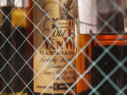 A bottle of Old Pappy Van Winkle bourbon is shown behind glass doors at a whiskey bar March 4, 2023.