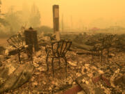 FILE - Chairs stand at the Gates post office in the aftermath of a fire in Gates, Ore., Sept 9, 2020. Oregon utility regulators have rejected a request from PacifiCorp that sought to limit its liability in wildfire lawsuits. KGW reports that the proposal would have limited the company&rsquo;s wildfire liability to just economic damages.