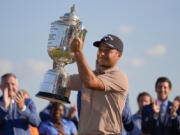 Xander Schauffele holds the Wanamaker trophy after winning the PGA Championship golf tournament at the Valhalla Golf Club, Sunday, May 19, 2024, in Louisville, Ky.