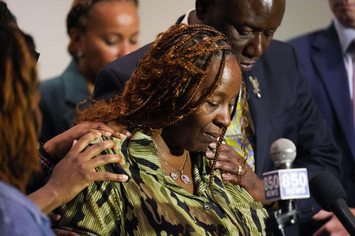 CORRECTS SERVICE BRANCH TO U.S. AIR FORCE INSTEAD OF U.S. NAVY - Chantemekki Fortson, mother of Roger Fortson, a U.S. Air Force senior airman, is comforted as she speaks about her son during a news conference regarding his death, with attorney Ben Crump, behind, Thursday, May 9, 2024, in Fort Walton Beach, Fla. Fortson was shot and killed by police in his apartment, May 3, 2024.