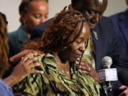 CORRECTS SERVICE BRANCH TO U.S. AIR FORCE INSTEAD OF U.S. NAVY - Chantemekki Fortson, mother of Roger Fortson, a U.S. Air Force senior airman, is comforted as she speaks about her son during a news conference regarding his death, with attorney Ben Crump, behind, Thursday, May 9, 2024, in Fort Walton Beach, Fla. Fortson was shot and killed by police in his apartment, May 3, 2024.