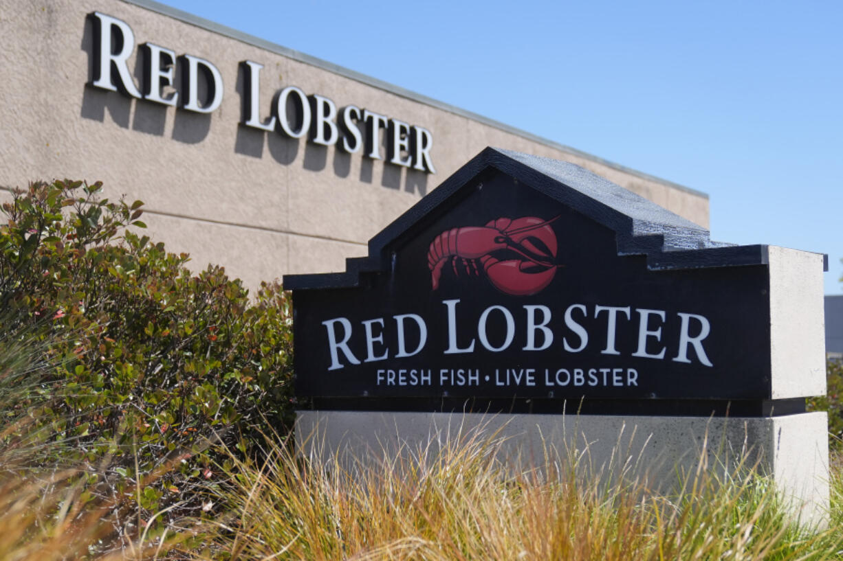 FILE - Signs for a Red Lobster restaurant are shown in San Bruno, Calif., Tuesday, May 14, 2024. Red Lobster has filed for Chapter 11 bankruptcy protection days after shuttering dozens of restaurants. The seafood chain has been struggling for some time with lease and labor costs piling up in recent years and also promotions like its iconic all-you-can-eat shrimp deal.