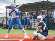 Ridgefield players cheer from the dugout as Ridgefield's Tava Whitlow (3) stands in the batter's box during the Class 2A District 4 softball tournament against Aberdeen on Thursday, May 16, 2024, in Chehalis.