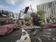 FILE - A sapper inspects fragments of a Russian air bomb that hit a living area injuring ten in Kharkiv, Ukraine, May 22, 2024. Two U.S. officials say the Biden administration is expected to announce an additional $275 million in military aid for Ukraine on Friday. It comes as Kyiv struggles to hold off advances by Russian troops in the Kharkiv region.