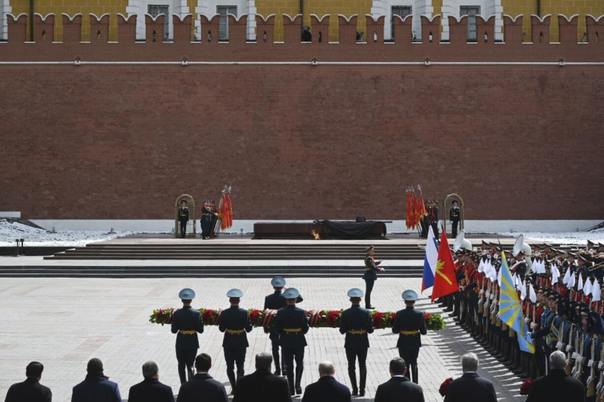 Russian President Vladimir Putin and foreign leaders take part in a wreath laying ceremony at the Tomb of the Unknown Soldier in the Alexander Garden on Victory Day, which marks the 79th anniversary of the victory over Nazi Germany in World War Two near the Kremlin in Moscow, Russia, Thursday, May 9, 2024.