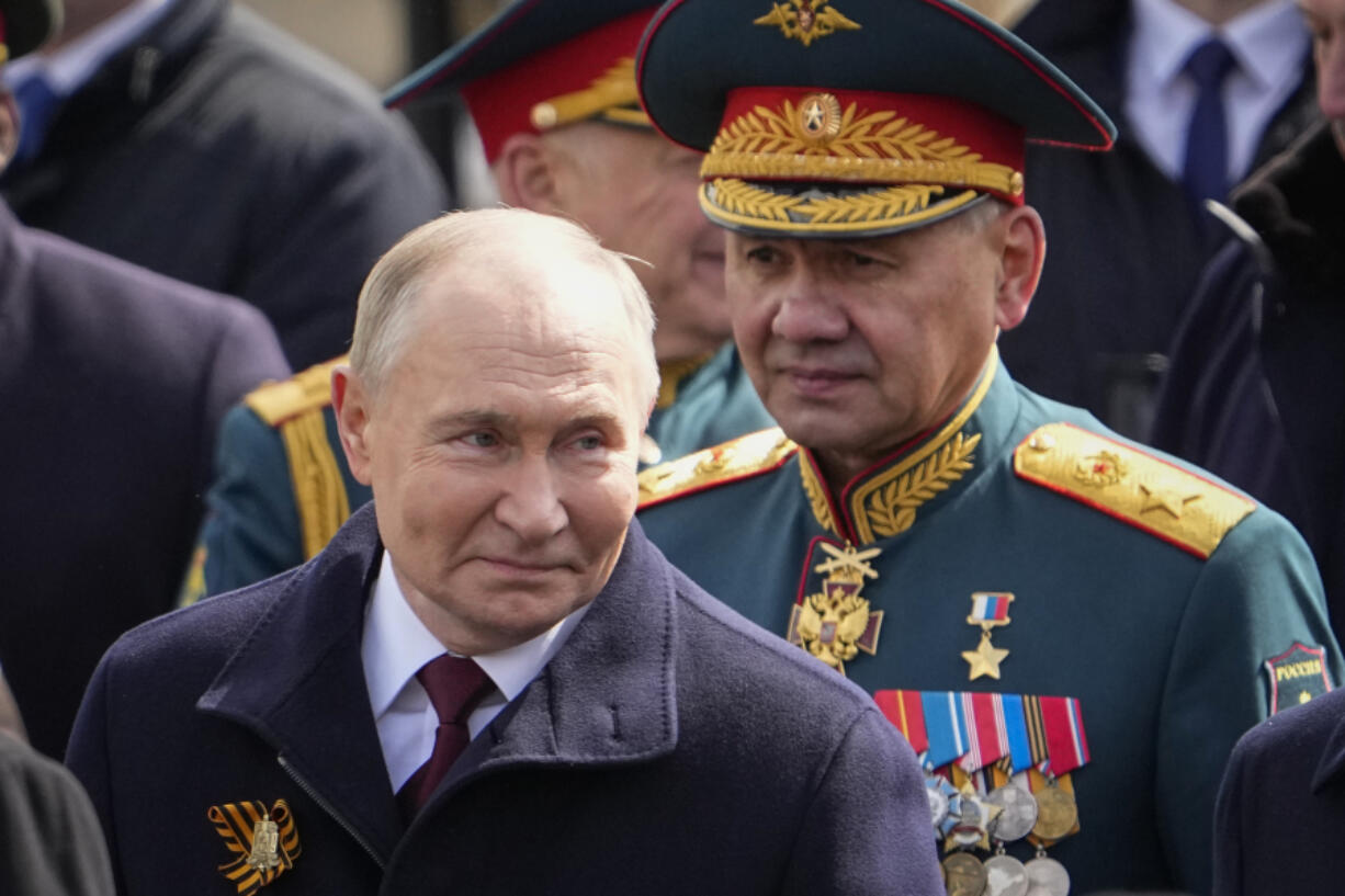 Russian President Vladimir Putin, left and Russian Defense Minister Sergei Shoigu, right, leave Red Square after the Victory Day military parade in Moscow, Russia, Thursday, May 9, 2024, marking the 79th anniversary of the end of World War II.