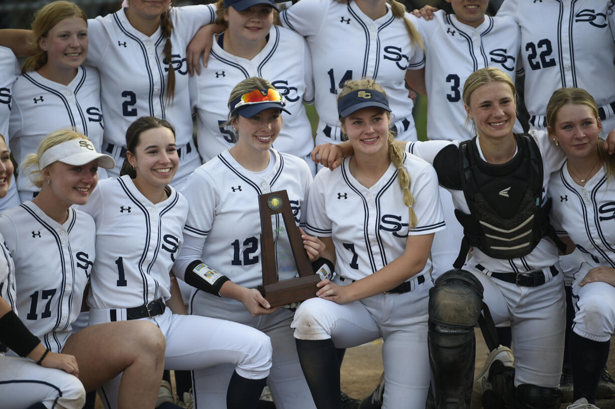 Seniors Ellie Forster (12) and Alyssa Mancuso (7) hold the runner-up trophy after Seton Catholic lost to Royal 16-4 in the Class 1A state softball championship game at Columbia Playfields in Richland on Saturday, May 25, 2024.