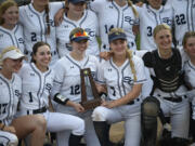 Seniors Ellie Forster (12) and Alyssa Mancuso (7) hold the runner-up trophy after Seton Catholic lost to Royal 16-4 in the Class 1A state softball championship game at Columbia Playfields in Richland on Saturday, May 25, 2024.