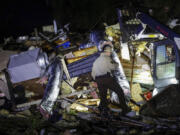 An Oklahoma State Highway Patrol trooper searches storm damage Tuesday, May 7, 2024 in Barnsdall, Okla.