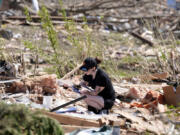 Jena Wiggins looks to recover items from her husband&rsquo;s grandparents&rsquo; tornado-damaged home, Thursday, May 23, 2024, in Greenfield, Iowa.