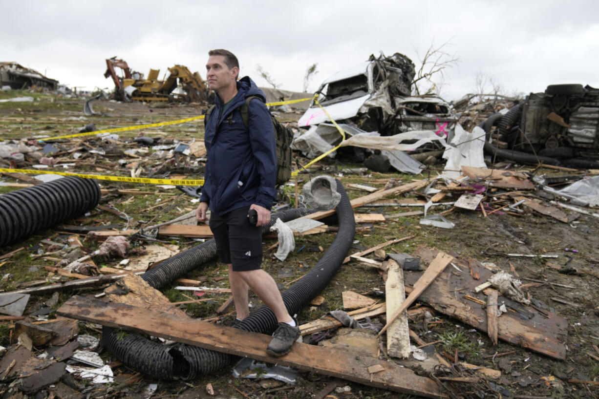 Brian Gutmann, of Creston, Iowa, looks over tornado-damaged property, Tuesday, May 21, 2024, in Greenfield, Iowa.