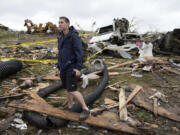 Brian Gutmann, of Creston, Iowa, looks over tornado-damaged property, Tuesday, May 21, 2024, in Greenfield, Iowa.