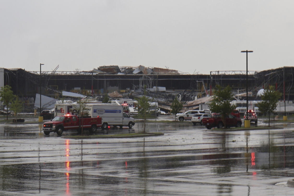 Emergency vehicles respond after a tornado damaged a FedEx facility in Portage, Mich., Tuesday, May 7, 2024.