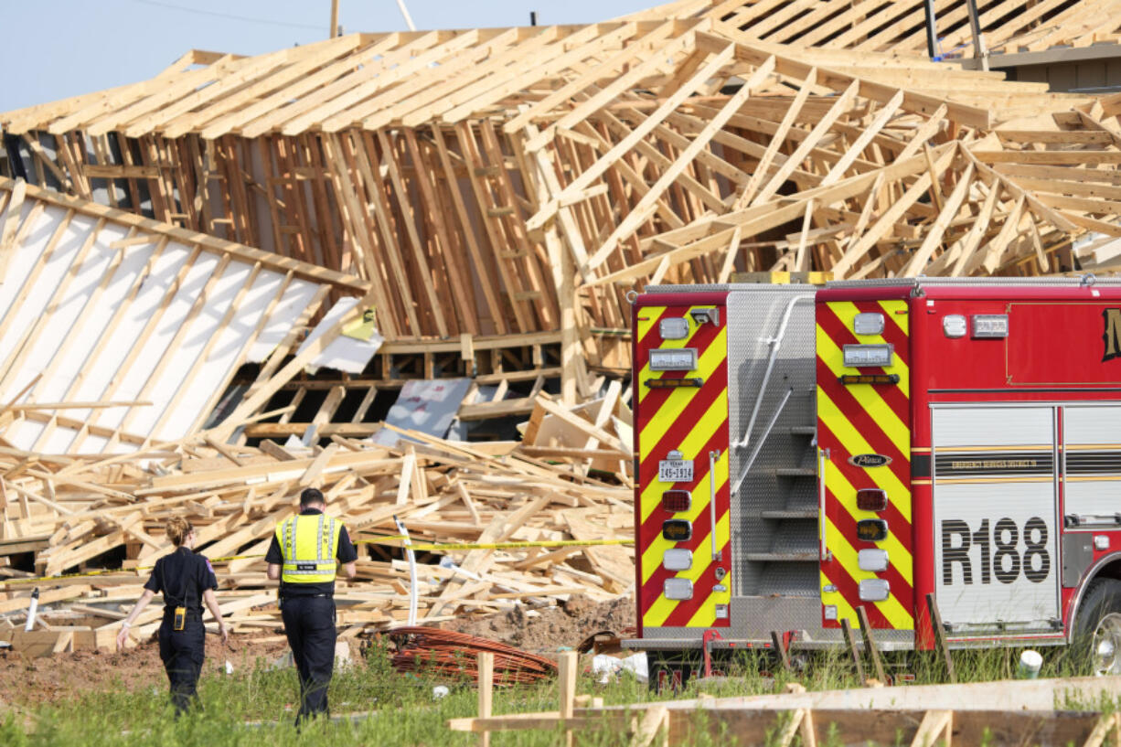 Magnolia Fire officials investigate the scene of a collapsed house that resulted in a fatality on Tuesday, May 28, 2024 in Magnolia, Texas.  One construction worker was killed when the frames of two single-family homes that were under construction fell as a strong, fast-moving storm moved across Montgomery County, officials said.