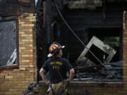 Houston Fire Department Senior Captain Chris Delbello surveys a damaged home after a fire Tuesday, May 28, 2024, in the Third Ward neighborhood in Houston. Neighbors said the house caught fire as a storm moved through the area.