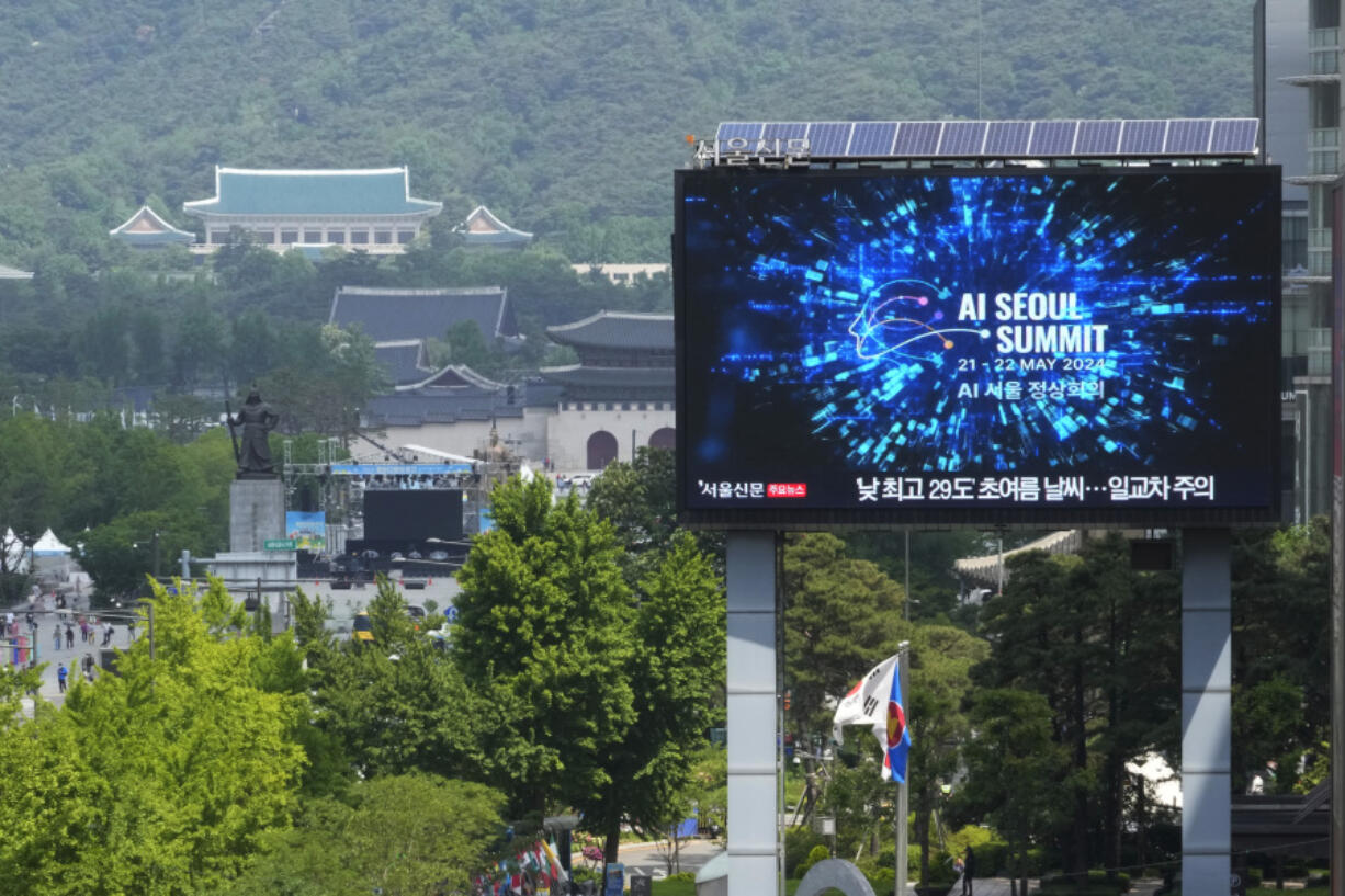 A screen shows an announcement of the AI Seoul Summit in Seoul, South Korea, Tuesday, May 21, 2024. World leaders are expected to adopt a new agreement on artificial intelligence when they gather virtually Tuesday to discuss AI&rsquo;s potential risks but also ways to promote its benefits and innovation.