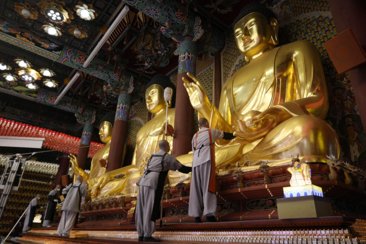 Buddhists monks clean Buddha statues May 7 ahead of the upcoming birthday of Buddha at the Jogye temple in Seoul, South Korea.