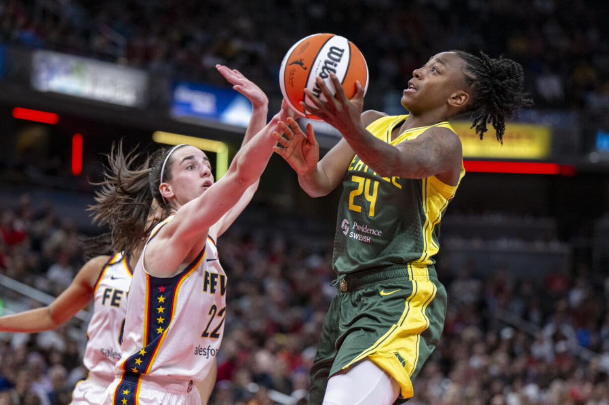 Seattle Storm guard Jewell Loyd (24) shoots against Indiana Fever guard Caitlin Clark (22) during the second half of a WNBA basketball game Thursday, May 30, 2024, in Indianapolis.