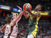 Seattle Storm guard Jewell Loyd (24) shoots against Indiana Fever guard Caitlin Clark (22) during the second half of a WNBA basketball game Thursday, May 30, 2024, in Indianapolis.