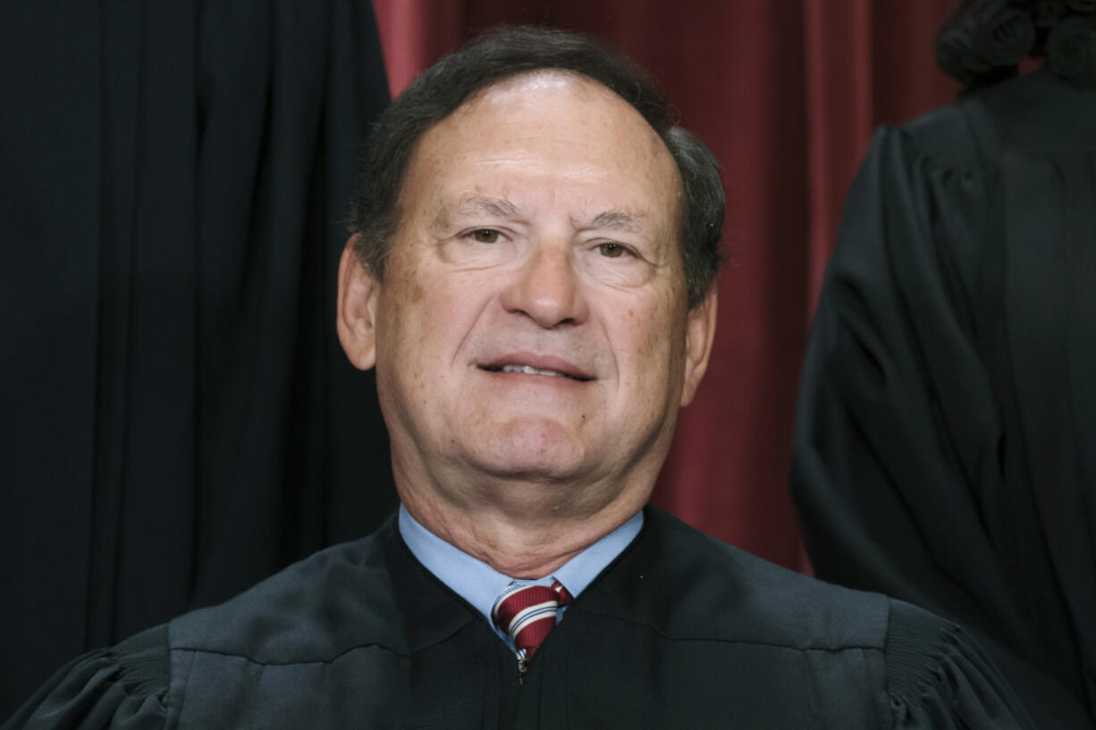 FILE - Associate Justice Samuel Alito joins other members of the Supreme Court as they pose for a new group portrait, Oct. 7, 2022, at the Supreme Court building in Washington. An upside-down American flag, a symbol associated with former President Donald Trump&rsquo;s false claims of election fraud, was displayed outside the home of Supreme Court Justice Samuel Alito in January 2021, The New York Times reported May 16. (AP Photo/J.