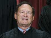 FILE - Associate Justice Samuel Alito joins other members of the Supreme Court as they pose for a new group portrait, Oct. 7, 2022, at the Supreme Court building in Washington. An upside-down American flag, a symbol associated with former President Donald Trump&rsquo;s false claims of election fraud, was displayed outside the home of Supreme Court Justice Samuel Alito in January 2021, The New York Times reported May 16. (AP Photo/J.