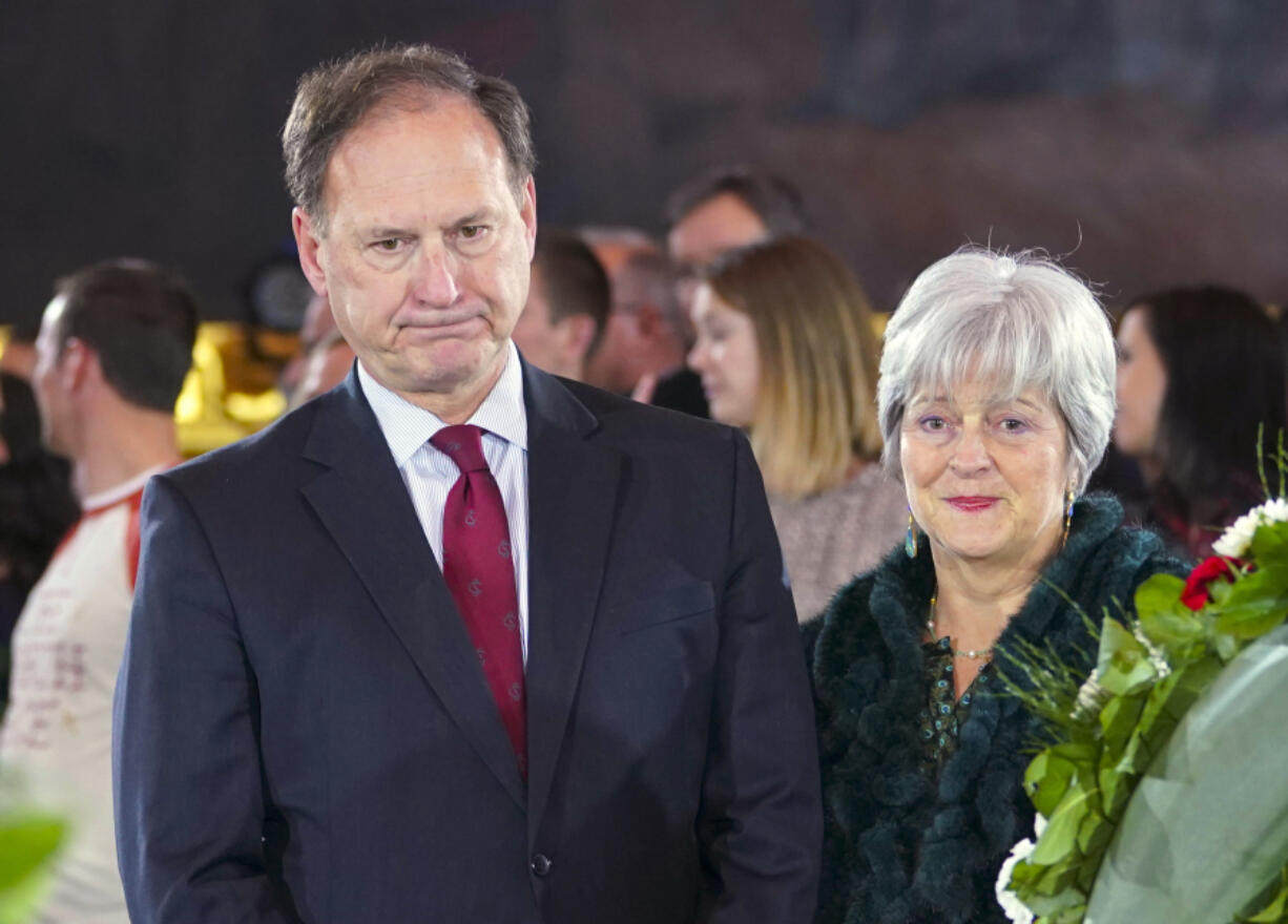 FILE - Supreme Court Justice Samuel Alito Jr., left, and his wife Martha-Ann Alito, pay their respects at the casket of Reverend Billy Graham at the Rotunda of the U.S. Capitol Building in Washington, Feb. 28, 2018. An upside-down American flag was displayed outside of Alito&rsquo;s home Jan. 17, 2021, days after former President Donald Trump supporters stormed the U.S. Capitol, The New York Times reports. It&rsquo;s a symbol associated with Trump&rsquo;s false claims of election fraud.  &ldquo;It was briefly placed by Mrs. Alito in response to a neighbor&rsquo;s use of objectionable and personally insulting language on yard signs,&rdquo; Alito said in an emailed statement to the newspaper.