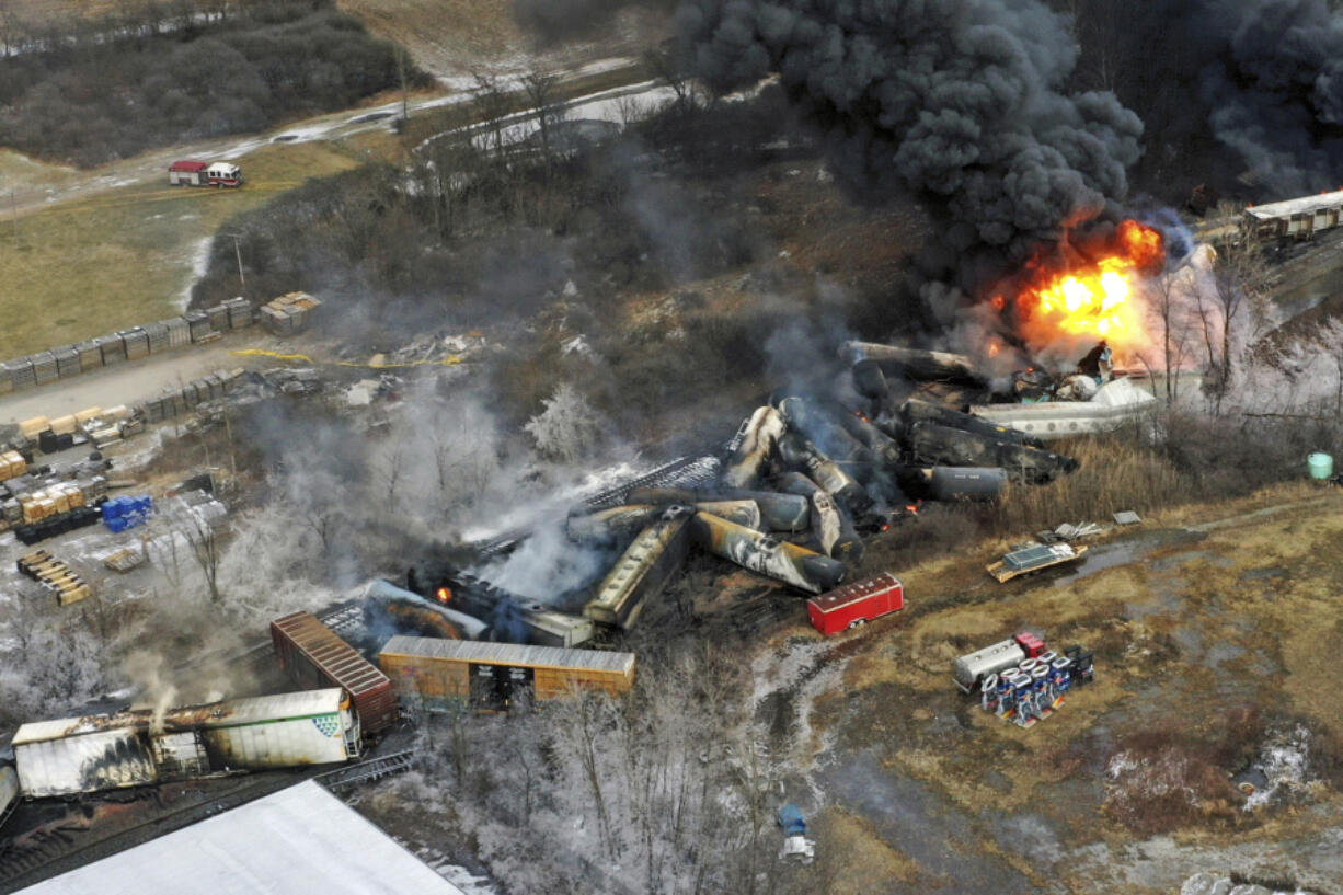 FILE - Debris from a Norfolk Southern freight train lies scattered and burning along the tracks on Feb. 4, 2023, the day after it derailed in East Palestine, Ohio. A federal judge has signed off Tuesday, May 21, 2024, on the $600 million class action settlement over last year&#039;s disastrous Norfolk Southern derailment in eastern Ohio, but many people who live near East Palestine are still wondering how much they will end up with out of the deal. (AP Photo/Gene J.