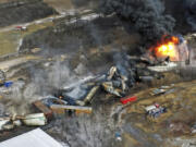 FILE - Debris from a Norfolk Southern freight train lies scattered and burning along the tracks on Feb. 4, 2023, the day after it derailed in East Palestine, Ohio. A federal judge has signed off Tuesday, May 21, 2024, on the $600 million class action settlement over last year&#039;s disastrous Norfolk Southern derailment in eastern Ohio, but many people who live near East Palestine are still wondering how much they will end up with out of the deal. (AP Photo/Gene J.