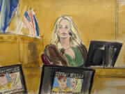 Stormy Daniels testifies on the witness stand as a promotional image for one of her shows featuring an image of Trump is displayed on monitors in Manhattan criminal court, Thursday, May 9, 2024, in New York.