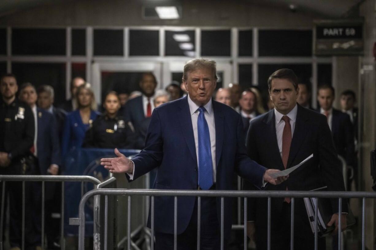 Former President Donald Trump speaks to reporters alongside his attorney Todd Blanche, right, during his ongoing trial at Manhattan Criminal Court in New York, Monday, May 20, 2024.