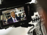 Former President Donald Trump, seen through a camera viewfinder, speaks to members of the media at Manhattan criminal court in New York, on May 2, 2024.