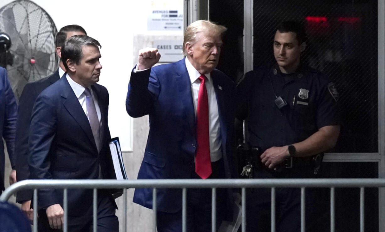 Former President Donald Trump raises his fist as he walks to the courtroom after a break in his trial at Manhattan criminal court in New York, on Friday, Friday, May 10, 2024.  (Timothy A.