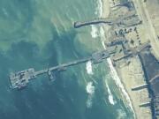 FILE - The image provided by U.S, Central Command, shows U.S. Army soldiers assigned to the 7th Transportation Brigade (Expeditionary), U.S. Navy sailors assigned to Amphibious Construction Battalion 1, and Israel Defense Forces placing the Trident Pier on the coast of Gaza Strip on May 16, 2024.  A U.S. built temporary pier that had been used to deliver additional humanitarian aid into Gaza was damaged by rough seas and has temporarily suspended operations. That&rsquo;s according to three U.S. officials who spoke to The Associated Press on Tuesday. (U.S.