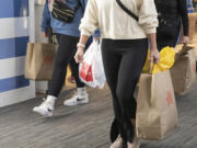 Black Friday shoppers carry shopping bags at Vancouver Mall on Nov. 24. Taxable retail sales rose faster in the third quarter here than in Washington&rsquo;s other urban areas.