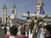 Pilgrims walk around a statue of the Blessed Virgin Mary near the church of St. James in Medjugorje, Bosnia and Herzegovina, some 120 kilometers (75 miles) south of the Bosnian capital of Sarajevo on Sunday, June 25, 2006. On Friday, May 17, 2024, the Vatican will issue revised norms for discerning apparitions &ldquo;and other supernatural phenomena,&rdquo; updating a set of guidelines first issued in 1978.