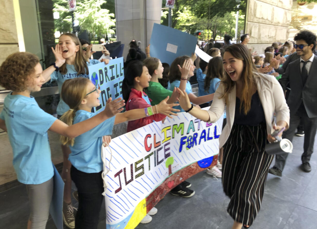 FILE - Kelsey Juliana, of Eugene, Ore., a lead plaintiff who is part of a lawsuit by a group of young people who say U.S. energy policies are causing climate change and hurting their future, greets supporters outside a federal courthouse, June 4, 2019, in Portland, Ore. A 9th U.S. Circuit Court of Appeals panel on Wednesday, May 1, 2024, rejected a long-running lawsuit brought by young Oregon-based climate activists who argued that the U.S. government&rsquo;s role in climate change violated their constitutional rights.