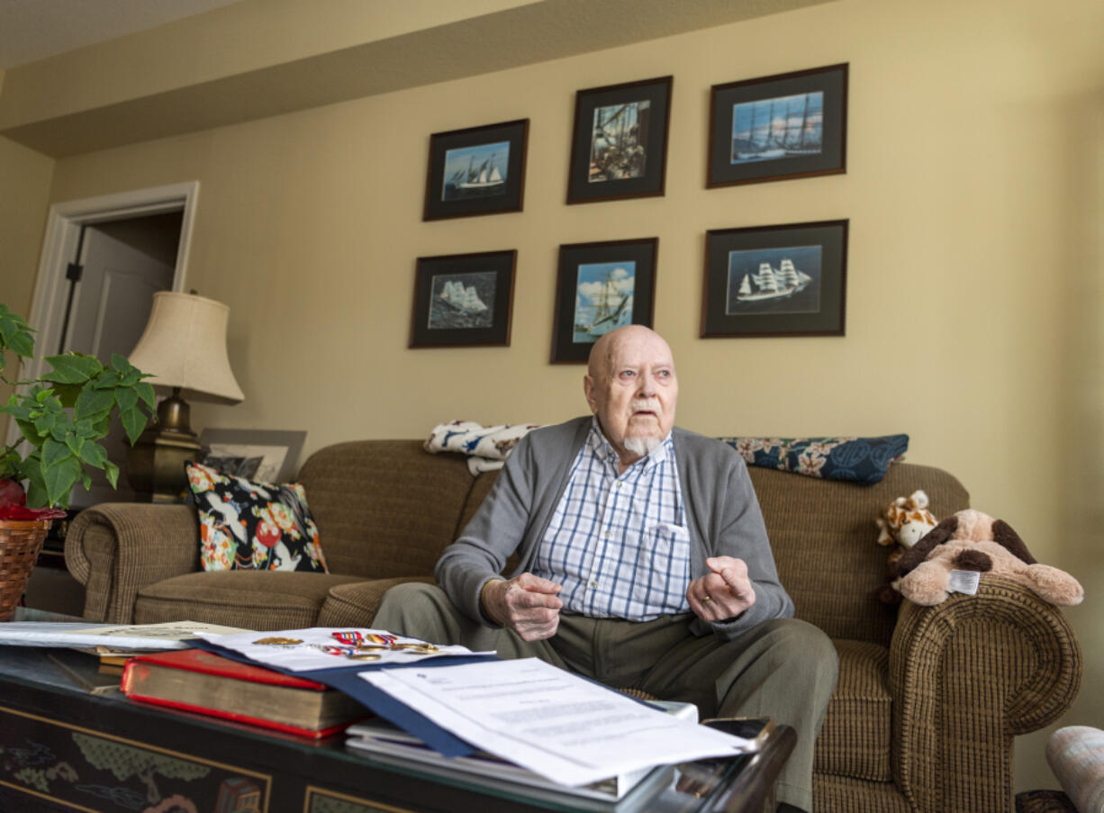 Images of sailing ships decorate the wall behind World War II veteran and merchant mariner Julian "Thorne" Hilts at his apartment in Vancouver.