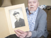 World War II veteran Julian &ldquo;Thorne&rdquo; Hilts displays a photo of himself when he was a commissioned Navy officer.