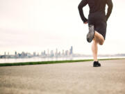 A man runs on the West Seattle Alki Beach jogging and bike path on an early morning, (iStock.com)