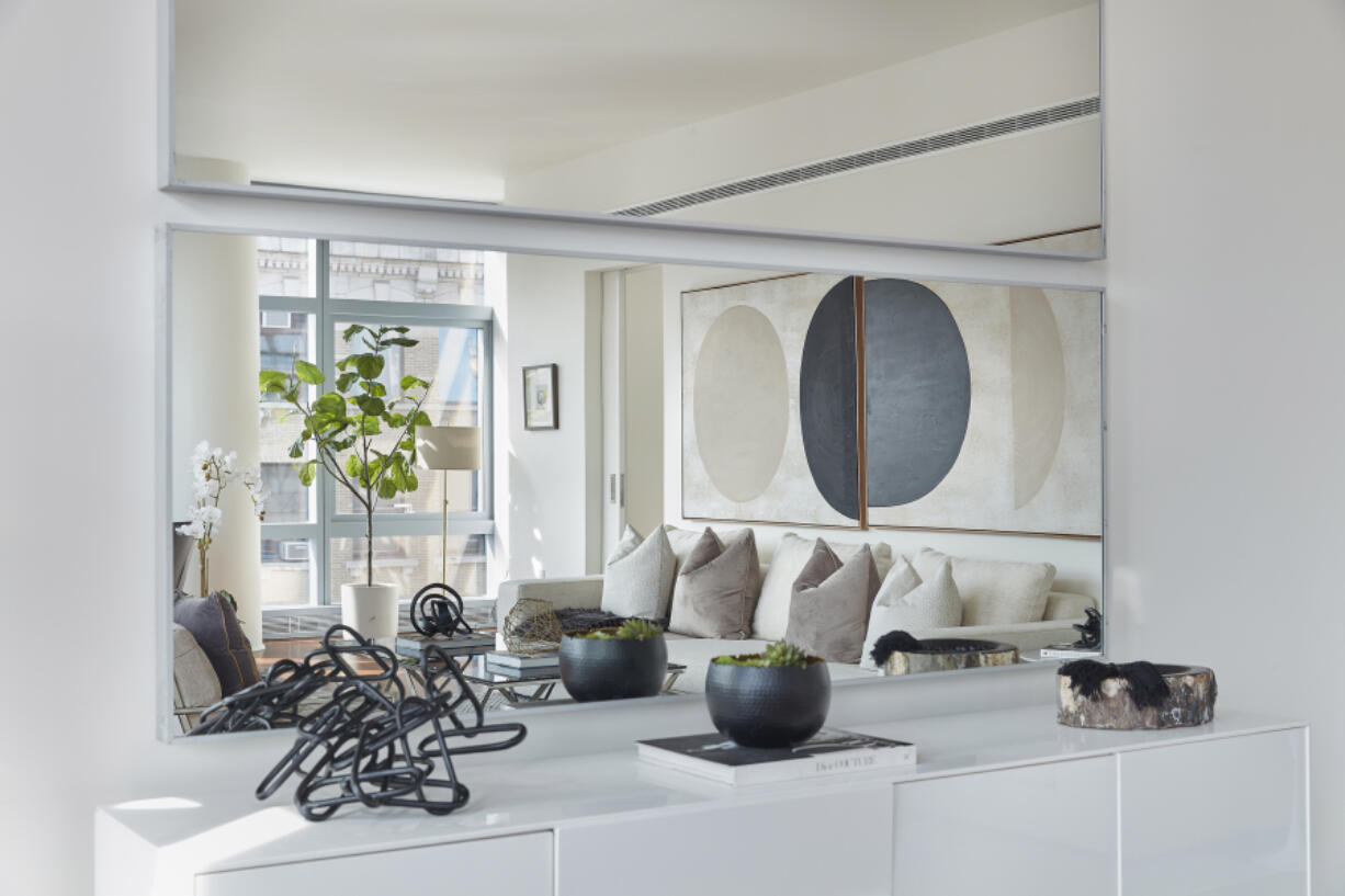 Horizontal frameless mirrors help reflect art in a living space.