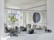 Horizontal frameless mirrors help reflect art in a living space.