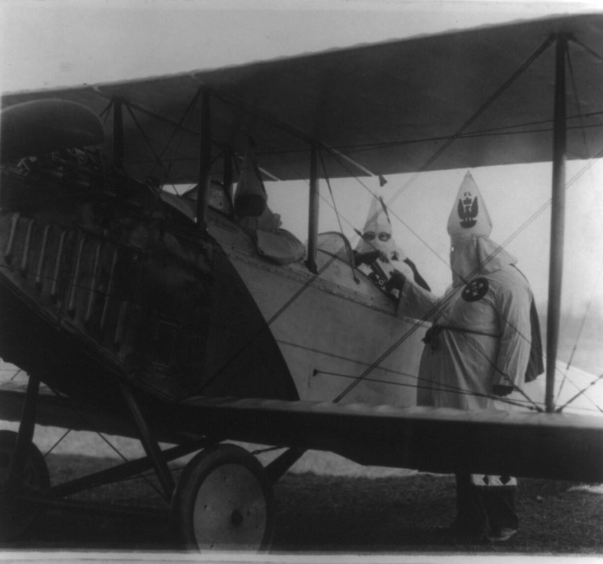 In August 1924, Kolumbia Klavern No. 1 flew an illuminated cross over the Clark County Fairgrounds at Bagley Downs. This photo, taken at an unknown location in 1922, shows two Klu Klux Klansmen climbing into a plane as they prepared to drop propaganda leaflets.