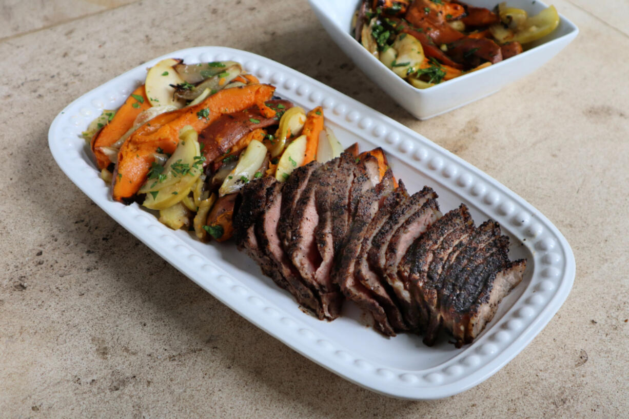 Coffee-rubbed steak is roasted in the oven with sweet potatoes, shallots and apples for an easy meal for two.