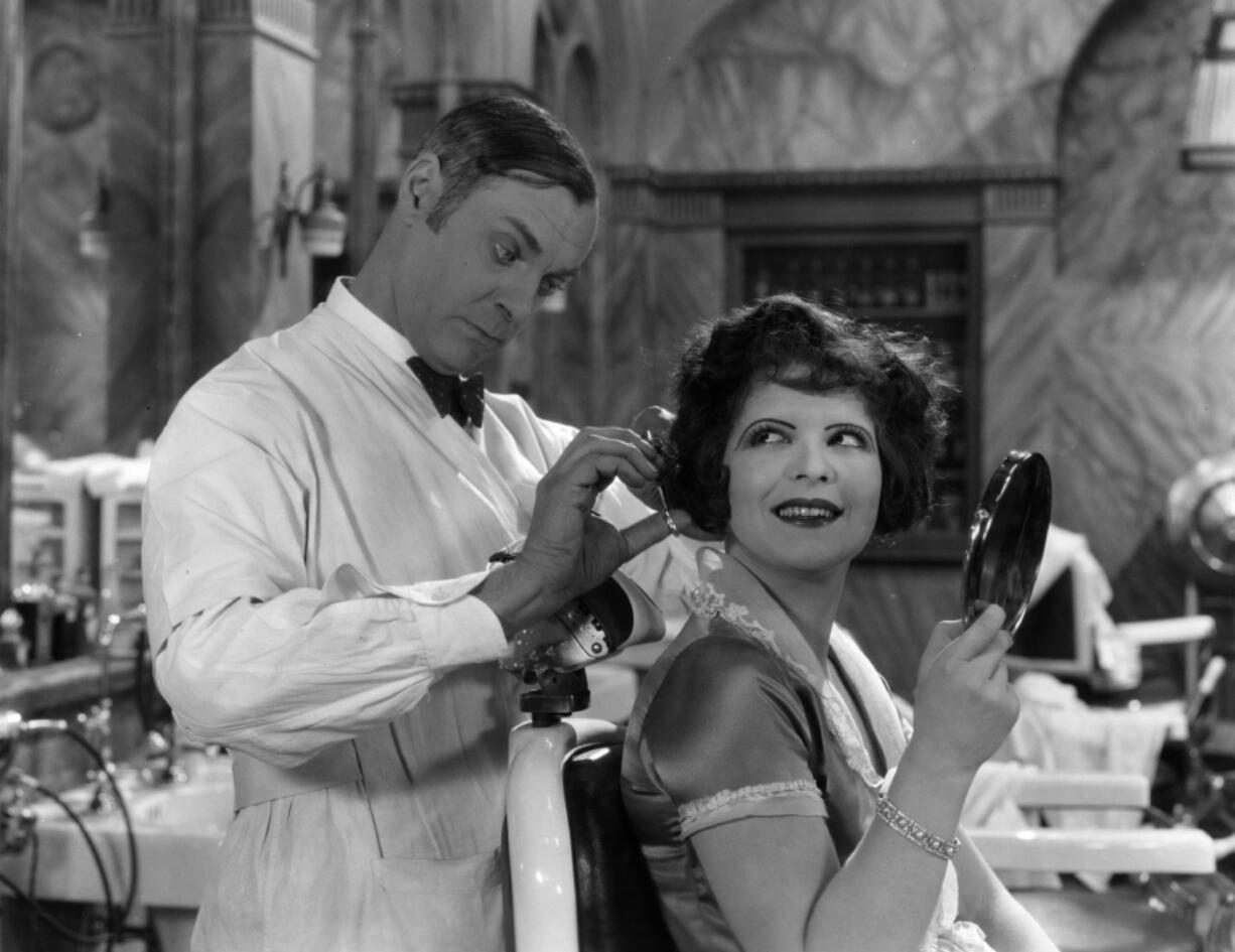 Clara Bow gets a haircut on set during a break from filming &ldquo;Red Hair&rdquo; for Paramount, circa 1928.